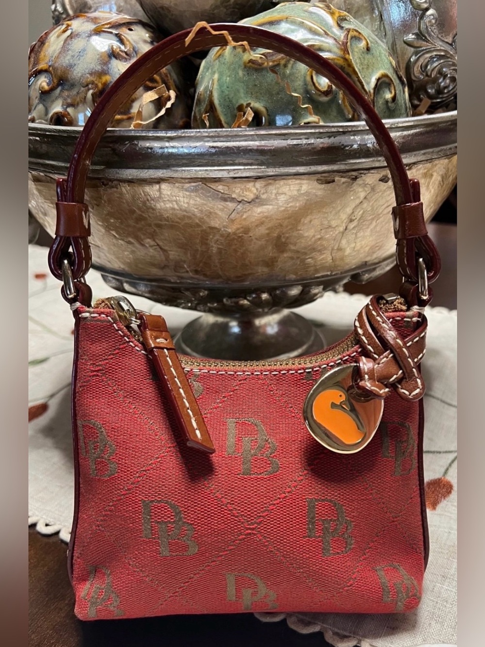 Dooney & Bourke Red Mini Shoulder Bag with Brown Trim and Orange Charm